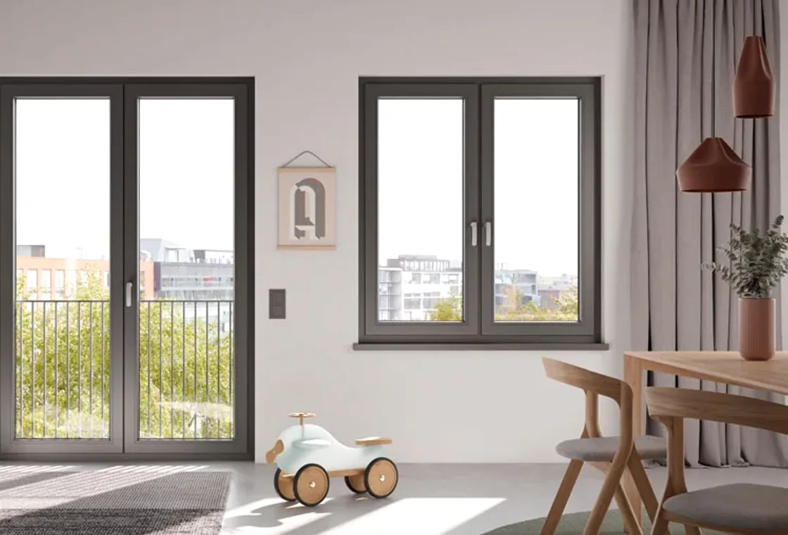 Okno i drzwi balkonowe w jasnym mieszkaniu z panelem sterowania smart home na ścianie